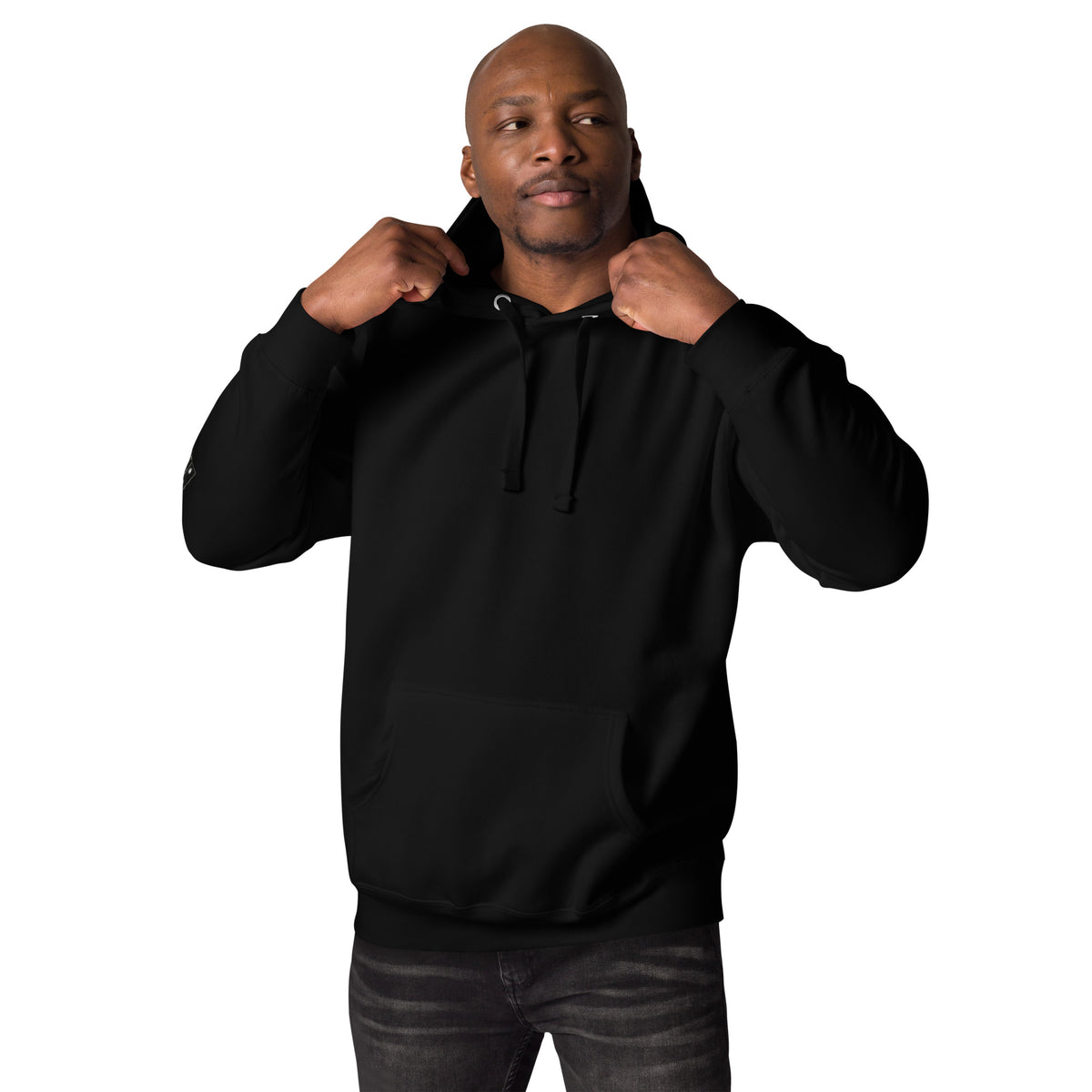 Man wearing a black hoodie shown from the front, with his hands on the hood.