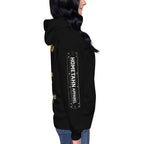 Woman shown from the right side wearing black hoodie with the words HOMETAHN APPAREL.