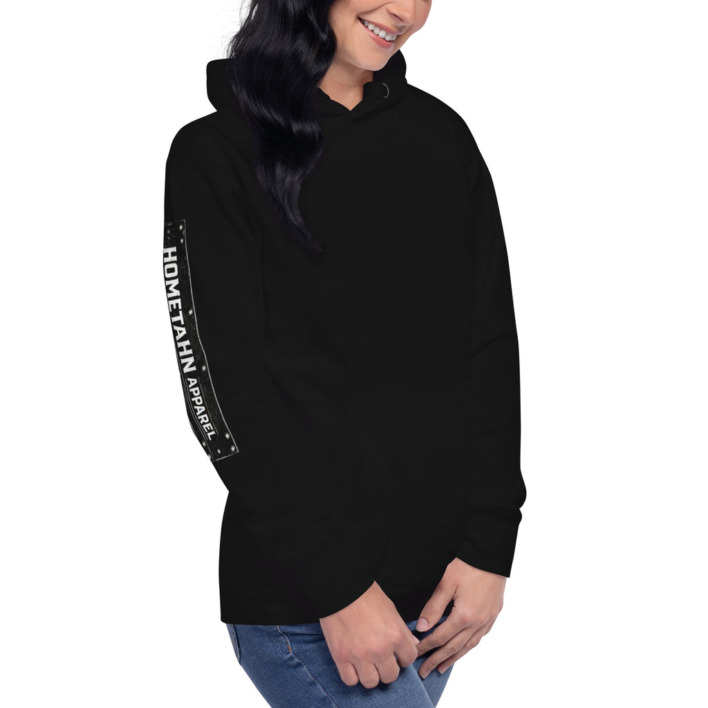 Woman wearing a black hoodie. shown from an angle with HOMETAHN APPAREL down the sleeve.