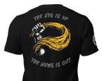 Black short-sleeve t-shirt shown from the back, featuring a large graphic print of a raised fist in white and yellow with the text 'THE JIG IS UP' above and 'THE NEWS IS OUT' below.