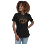 A woman wearing a short sleeve black t-shirt with an orange pumpkin engraved with "PGH".