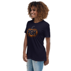 A woman with curly brown hair wearing a navy blue t-shirt with a pumpkin graphic that says 'PGH' in orange and black, paired with light-wash distressed jeans, set against a plain white background.